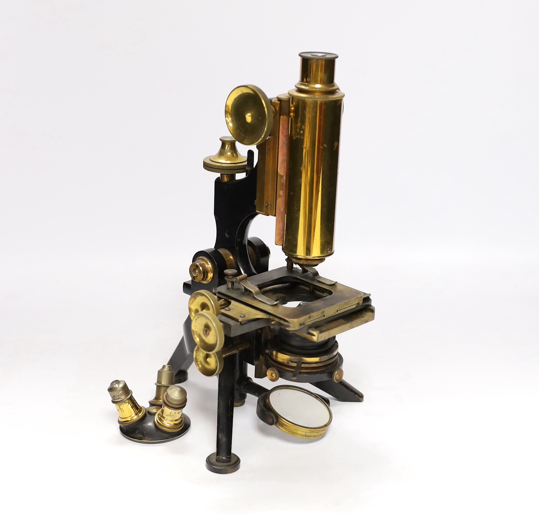A Victorian monocular brass and black enamel microscope by W. Watson & Sons, High Holborn, in a mahogany carrying case, Serial no.19919, with a number of alternative lens of different magnification, case 34.5cm high